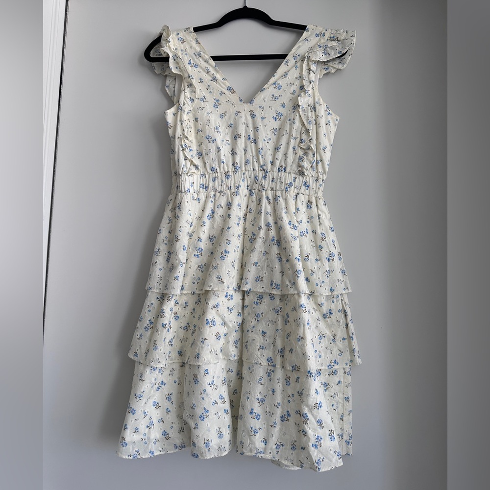 Mini dress with flower details and fringe layers.